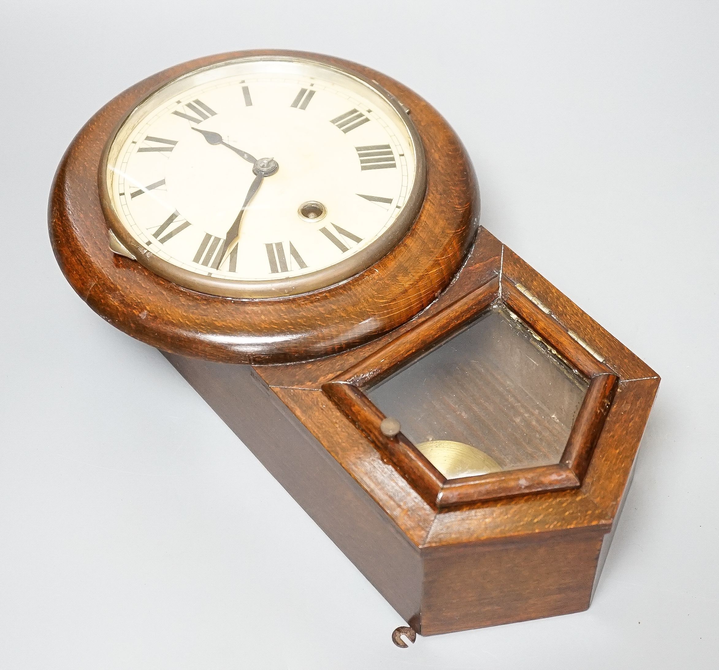 A small late 19th century beech drop dial timepiece with key and pendulum 31cm